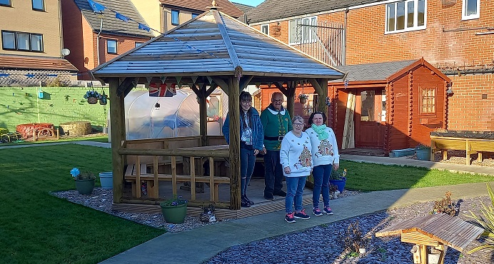 Community Connect service users enjoying their new garden pagoda.
