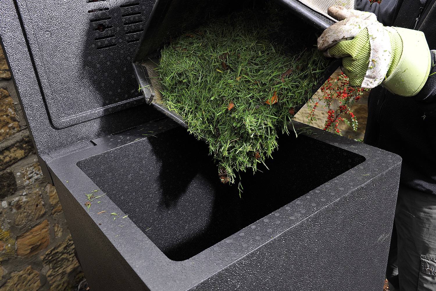 Grass being thrown in a bin