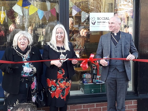 Cutting the ribbon at the opening of the Social Supermarket